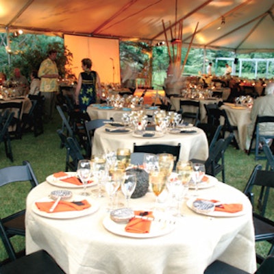 LongHouse founder Jack Lenor Larsen designed the event's decor, which featured linen tablecloths paired with black folding chairs and bronze African gourds at the center of tables. Small handheld drums were set at each place setting.
