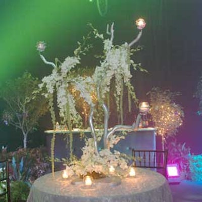 One of the centerpieces used branches with strands of flowers and votive candleholders, which added a glow to the room.