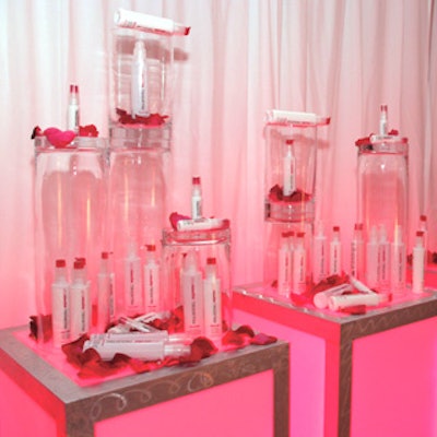 Jes Gordon displayed Express Style products inside, on top, and around upside-down vases on a table scattered with red flower petals.