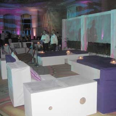 Nuage Designs Inc. set up lounges for celebrity guests with white furniture and lavender pillows, and a curtain made from strands of pearls by EventSource International.