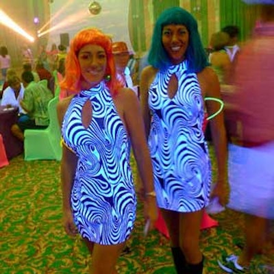 Hostesses kept the party going beneath black lights.
