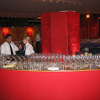 A red circular bar surrounded a column covered with red flowers.