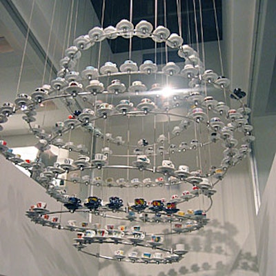 Carlos Bach, Illy's in-house art curator, designed the dramatic, swirling iron chandelier that holds more than 300 espresso cups and saucers with Illy-commissioned designs from artists including Jeff Koons and Louise Bourgeois.