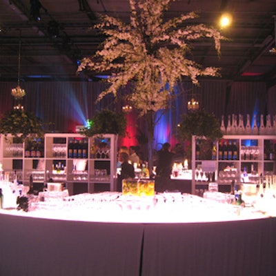 McNabb Roick created bars using a semicircle design with shelves and soaring floral arrangements for backdrops.