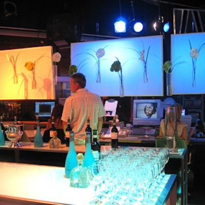 Hedge Floral Studios attached fresh flower stems to lit backdrops behind a bar in the greenroom.
