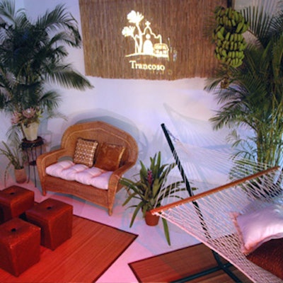 Jes Gordon accented wicker furniture, colorful ottomans, and pillow-dotted hammocks with lush palms and tropical flowers.