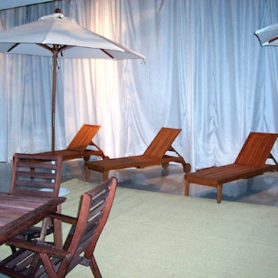 Wooden patio tables and lounge chairs were placed around the room to mimic a Sunday afternoon at the beach.