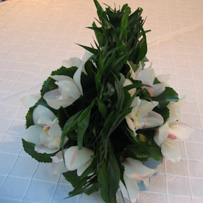 Centrepieces from Crimson Floral displayed low-lying white blooms flanked by a rounded, leafy centre, suggesting a Mohawk haircut.