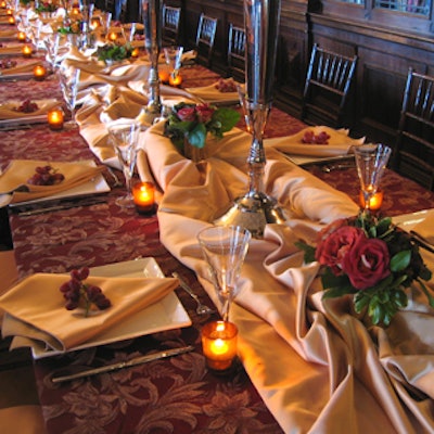 Table decor included fresh flowers, billowy fabrics, and napkins with grape-bunch treatments.