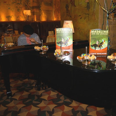 A black beret-wearing pianist played a grand piano decorated with candies and Madeline books.