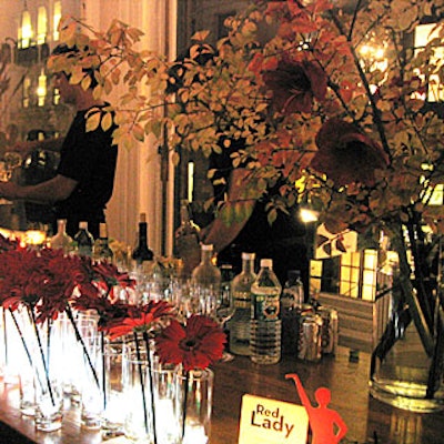 Serena Bass decorated the Harry's Loft with red gerbera daisies and red amaryllis blossoms attached to leafy branches sprawling from large vases at the launch of Women's Health magazine.
