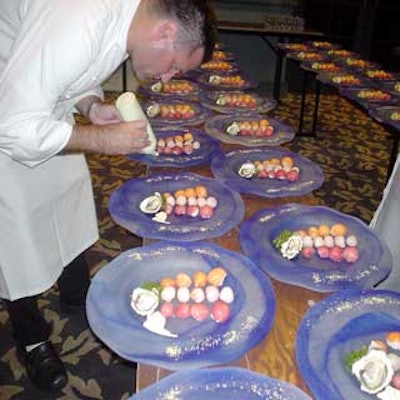 A Swan and Dolphin chef puts the finishing touches on plates of sushi.