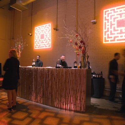 Bamboo covered the fronts of bars and a lattice pattern reminiscent of carved wood screens was projected onto the wall.