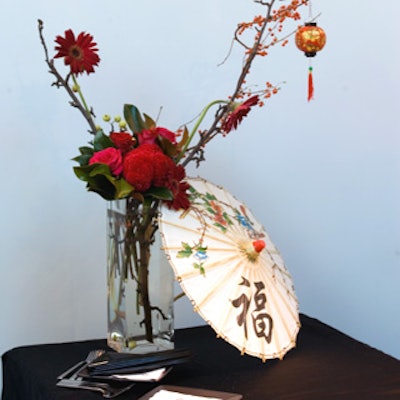Floral arrangements featured a mix including Chinese lantern plants, magnolia leaves, and apple branches.