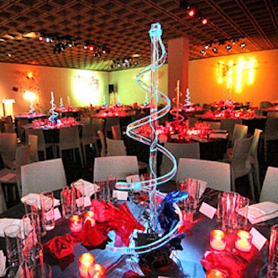 The Whitney Museum of American Art’s annual gala featured artist Richard Tuttle’s dramatic blue neon centerpieces on the dinner tabletops, which were also dotted with red votive candles.