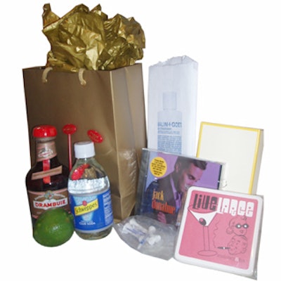 Gift bags included grooming products from Malin & Goetz, a leather notebook, a bottle of Drambuie, soda water, swizzle sticks, a lime, and a set of coasters.