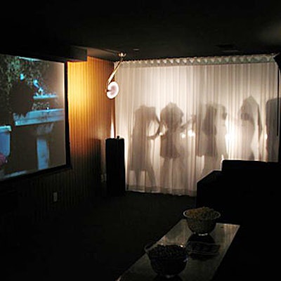 Headless mannequins holding cell phones playing a loop of the 60-second videos were placed behind a white curtain.