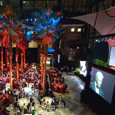 Tables with all-red or all-white color schemes formed the famous cross logo at the American Red Cross in Greater New York's centennial celebration ball at the Winter Garden.