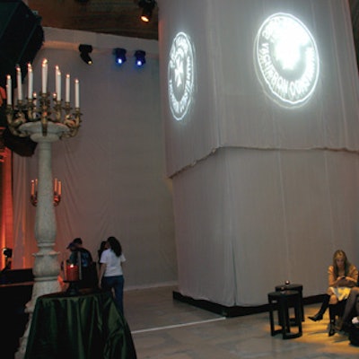 In the library’s grand Astor Hall, a box made from sheer gold and white fabric concealed a 12- by 12-foot trussing system.