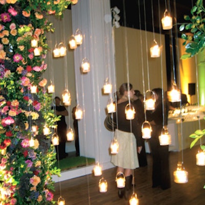 Candles dangled from a gate made from a trellis of roses and dahlias at the entrance.