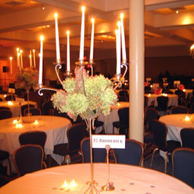 Elegant floral arrangements of green and pink hydrangeas poised high over the tables in golden pedestals were an homage to Matthew Broderick's fussy character Felix.