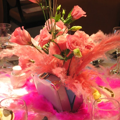 Flowers by Poppies arranged in pink Jeanne Lottie purses enlivened the dinner tables at the Liberty Grand for the Pink Bedroom fashion show and fund-raiser.