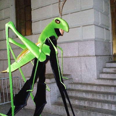 A stiltwalker in a grasshopper costume greeted guests outside the venue.