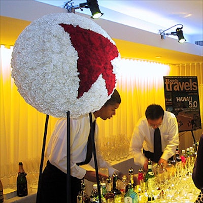 Two more carnation globes by Avi Adler decorated the bar at the Expedia Travels party.