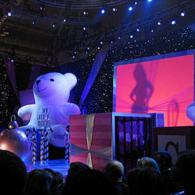 Burlesquer Dita von Teese performed a striptease behind a screen that magnified her into a larger-than-life silhouette.