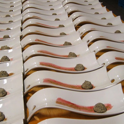 Soup bowls were prepared with porcini dust and mushroom custard before being filled with grappa and green tea consomm? by servers in front of the guests.