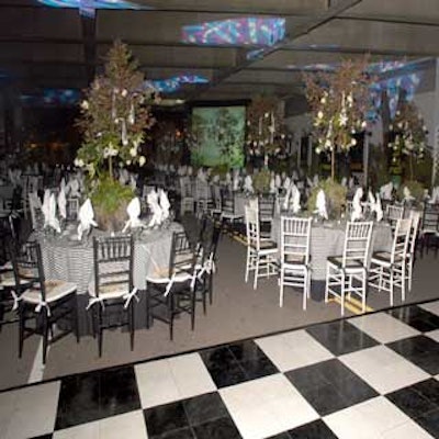 Black and white tables with rosebush centerpieces created a garden environment at the Tampa Museum of Art's Pavilion XX fund-raiser.