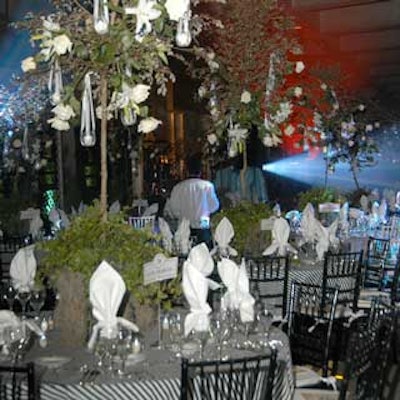 Floral Impressions created centerpieces of trees hung with white roses and calla lilies.