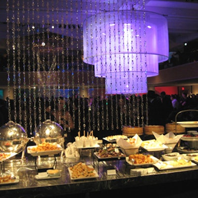 Reflective silver strands hung over the buffets for a shiny, decorative effect at the Country Music Awards’ official after-party, but the enormous sheer chandelier that capped the main bar dominated the space.