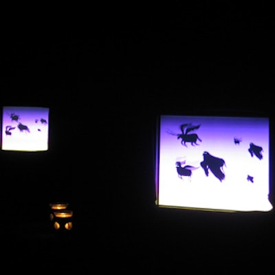 TV monitors framed by black drapes showed images of witches, bats, and other spooky Halloween characters.