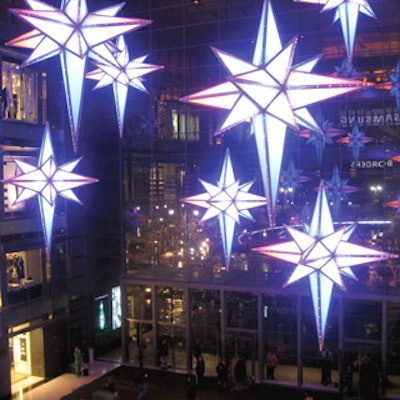 Time Warner Center's holiday decor features lights housed within multi-pointed stars that hang at different levels.