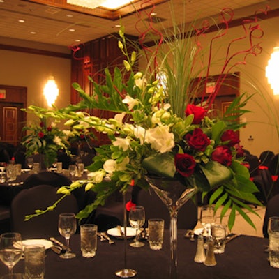 Floral arrangements in outsize martini glasses decorated the tables in the ballroom.