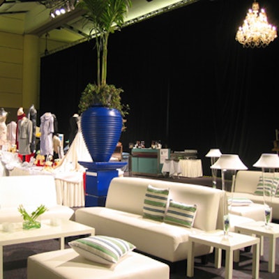 The silent auction area, with white lounge furniture, striped pillows, and large urns, hinted at the nautical theme.