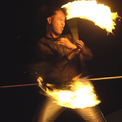 A fire dancer entertained on the red-lit Fire half of the party.