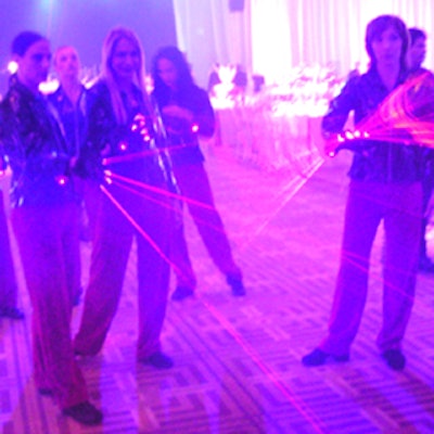 Laser-gloved greeters created a spectacle at the party's entrance.