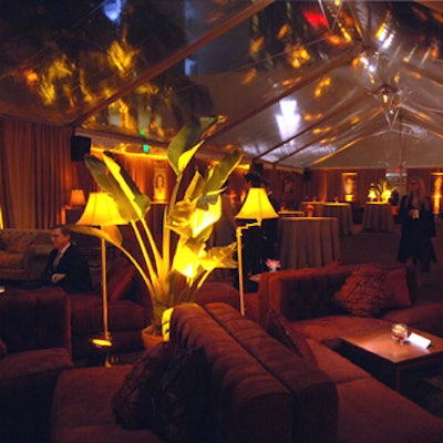 Under the 40- by 110-foot tent, Best Events went with a vintage 1940's look, bringing in potted banana palm plants in big brass pots, gilded mirrors, and heavy velvet draping.
