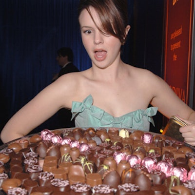 Actress Amber Tamblyn eyed a massive tray of chocolates in Godiva's lounge at the Beverly Hilton for In Style and Warner Brothers' Golden Globes party.