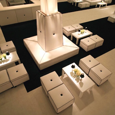 White couches with black piping sat on thick stripes of black carpet, which alternated with white.