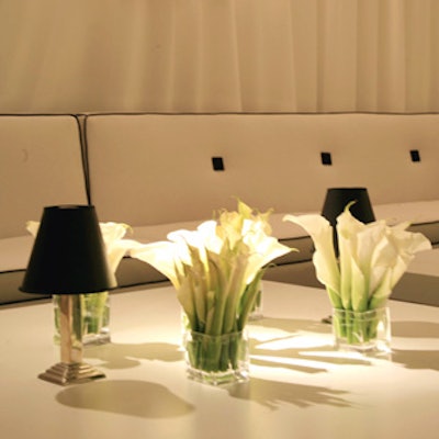 Right side up lilies filled small vases on the tabletops.