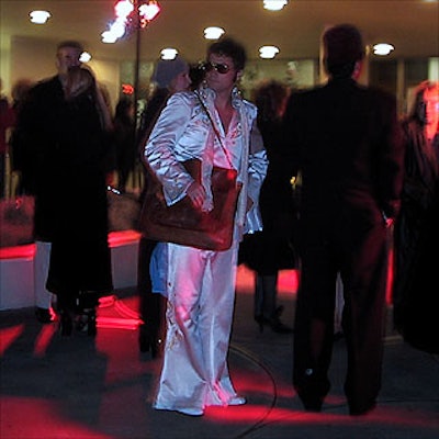 'The King' and other costumed revelers awaited entry to the Solomon R. Guggenheim Museum for the High Style Halloween ball. Stortz Lighting provided the orange spotlights.