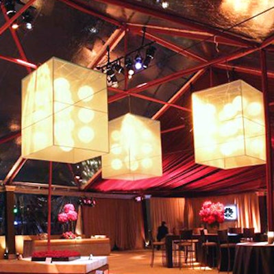 Three square-shaped fabric structures encased illuminated orbs to create bold geometric chandeliers.