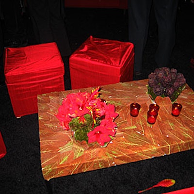 Red amaryllis, moss, and purple succulents appeared to grow out of the magolia-leaf plastered coffee tables.