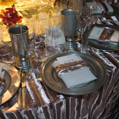 Kemble, Rose, and van Wyck mixed pewter place settings with a table overlay, chair covers, and napkin rings in silver faux fur.