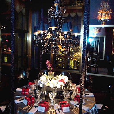 Baccarat’s visual director, Kelly Lafferty, incorporated Philippe Starck’s Darkside line of crystal—including the designer’s black crystal chandelier—into the dramatic table setting. To support the chandelier, a black gazebo-like structure was built to fit over the table and outfitted with a gray mirror ceiling. White orchids and a silver metallic organza overlay topped the table.