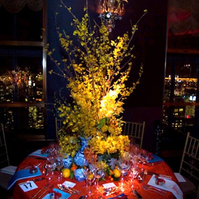 Stephen Elrod of textile company Lee Jofa used shades of yellow and orange orchids in blue and white porcelain vases for a Chinese look—with kumquats, oranges, and lemons spilling from the arrangement. A tangerine silk taffeta tablecloth had a quilted pattern of squares within squares and napkins were embroidered with the garden’s logo.