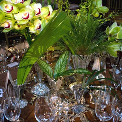 Artist Michele Oka Doner placed a glittering assortment of her highly textured silver vessels on the table and filled them with green orchids and a variety of leaves.